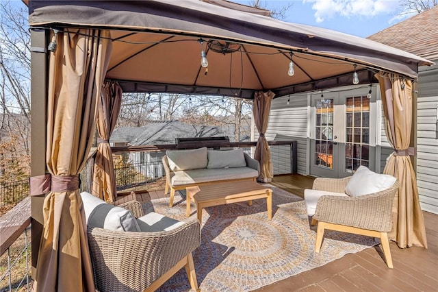 wooden terrace featuring a gazebo, french doors, and outdoor lounge area