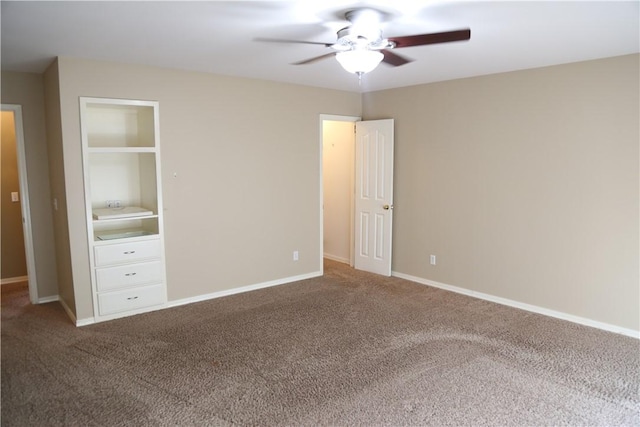 unfurnished bedroom with ceiling fan, carpet floors, and baseboards