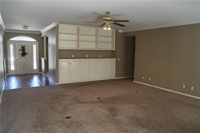 unfurnished living room featuring ceiling fan, baseboards, dark colored carpet, and crown molding