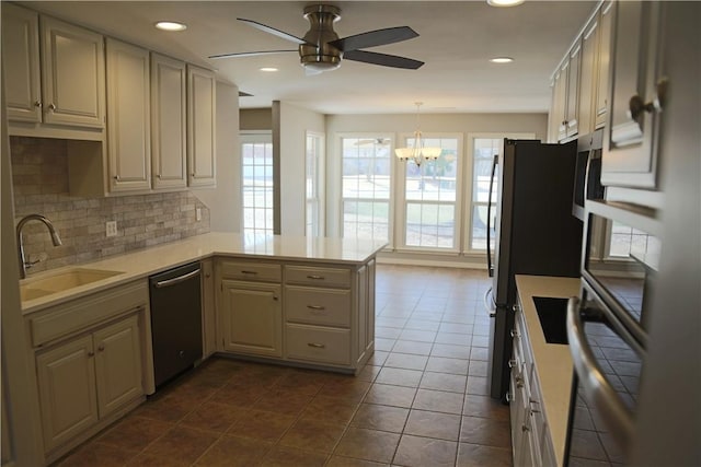 kitchen featuring a sink, plenty of natural light, a peninsula, and dishwasher