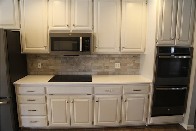 kitchen with appliances with stainless steel finishes, white cabinets, light countertops, and decorative backsplash