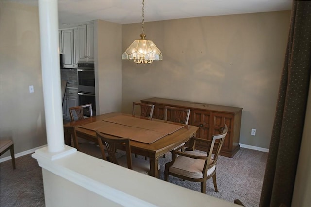 dining area featuring carpet and baseboards