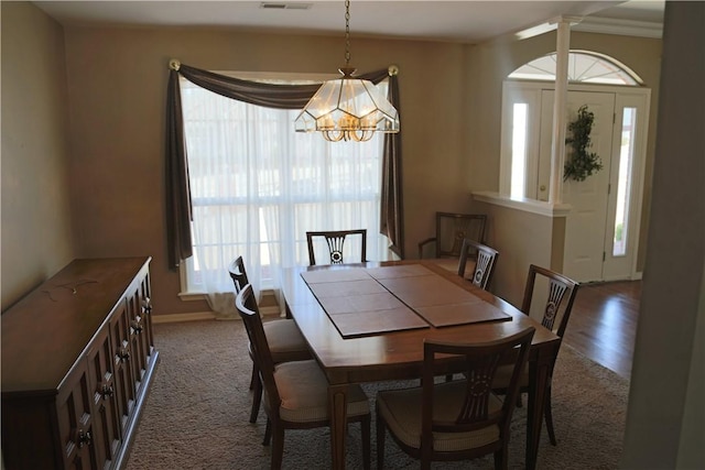 dining area with visible vents and a notable chandelier