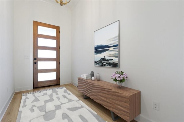 entryway with baseboards and wood finished floors