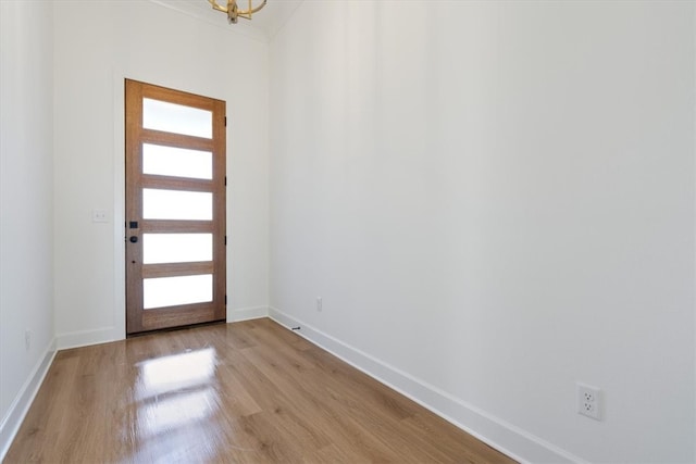 foyer featuring baseboards and wood finished floors