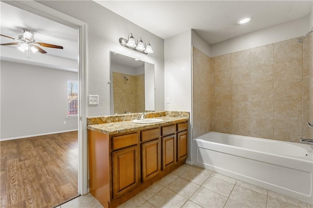 full bath featuring a ceiling fan, bathing tub / shower combination, vanity, and tile patterned floors