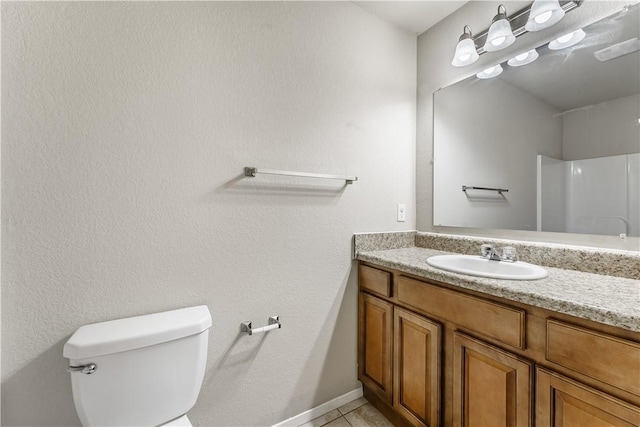 bathroom featuring toilet, tile patterned floors, and vanity