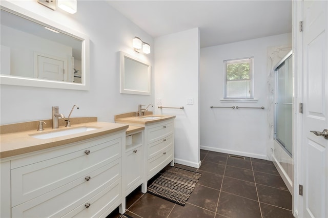 bathroom with shower / bath combination with glass door, visible vents, vanity, baseboards, and tile patterned floors