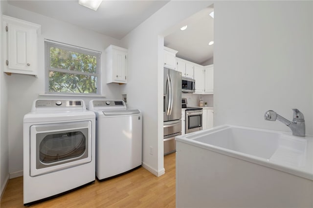 washroom featuring recessed lighting, baseboards, light wood-type flooring, independent washer and dryer, and cabinet space