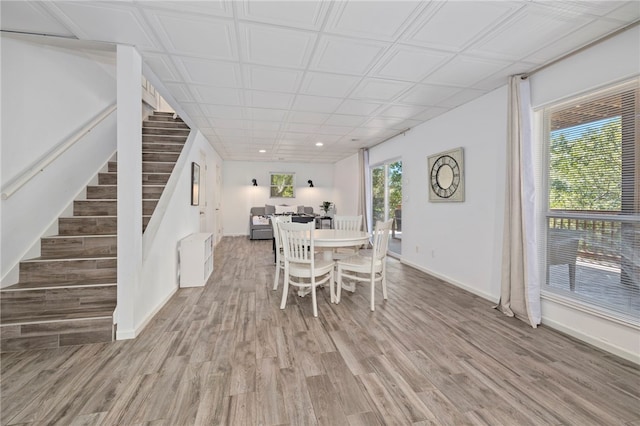 dining space with stairway, recessed lighting, light wood-style flooring, and baseboards