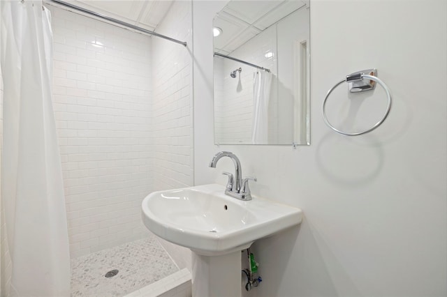 full bath with a shower stall and a sink