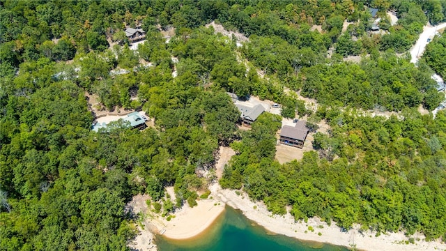 drone / aerial view featuring a water view and a forest view