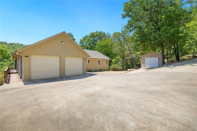 exterior space featuring a garage and an outbuilding