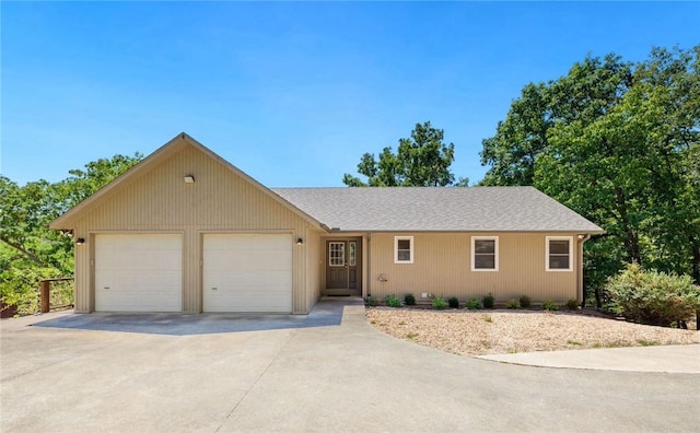 ranch-style house with an attached garage and driveway