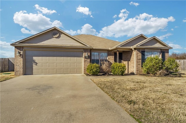 ranch-style home featuring a garage, concrete driveway, brick siding, and fence