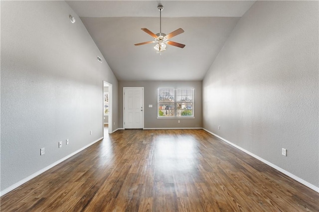 spare room featuring dark wood-style floors, ceiling fan, baseboards, and high vaulted ceiling