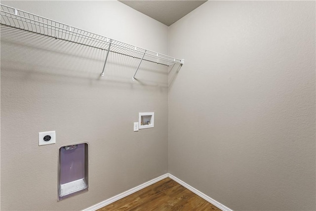 clothes washing area with hookup for a washing machine, laundry area, dark wood-type flooring, baseboards, and electric dryer hookup