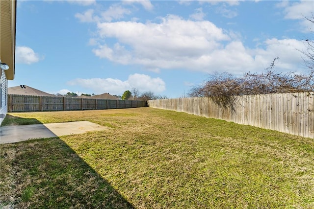 view of yard featuring a patio area and a fenced backyard