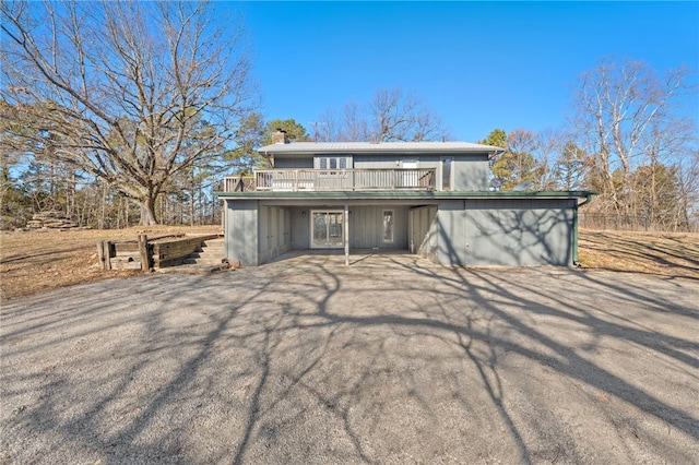 view of front of home with driveway and a wooden deck