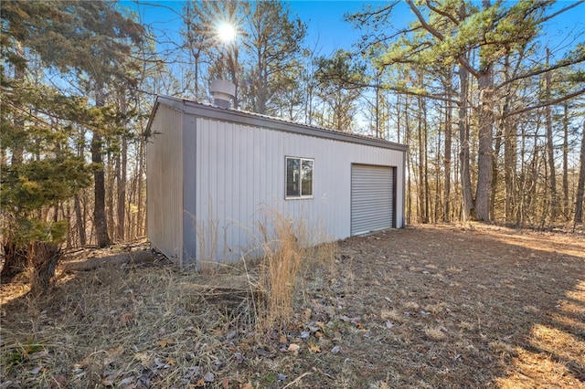 garage with dirt driveway