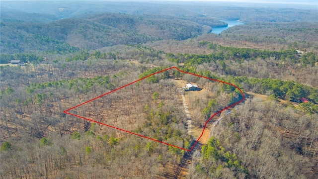 birds eye view of property featuring a view of trees