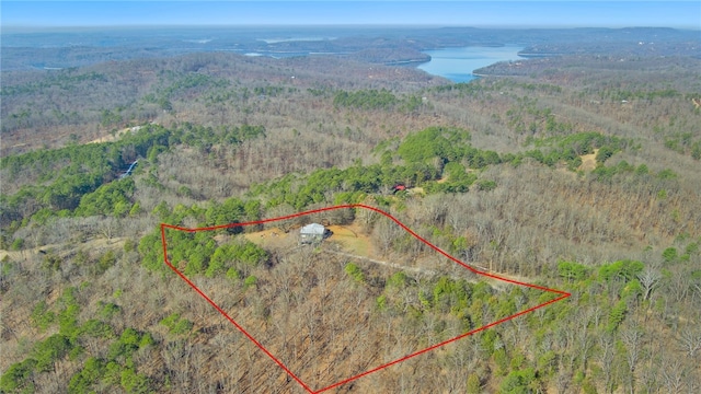 birds eye view of property with a view of trees