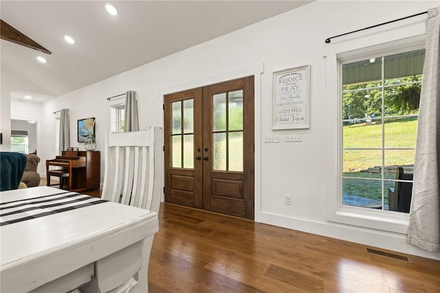 foyer featuring a healthy amount of sunlight, visible vents, and dark wood-style flooring