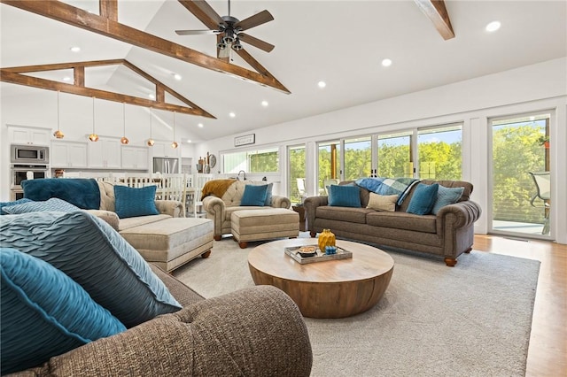 living area with ceiling fan, beamed ceiling, light wood-style floors, high vaulted ceiling, and recessed lighting