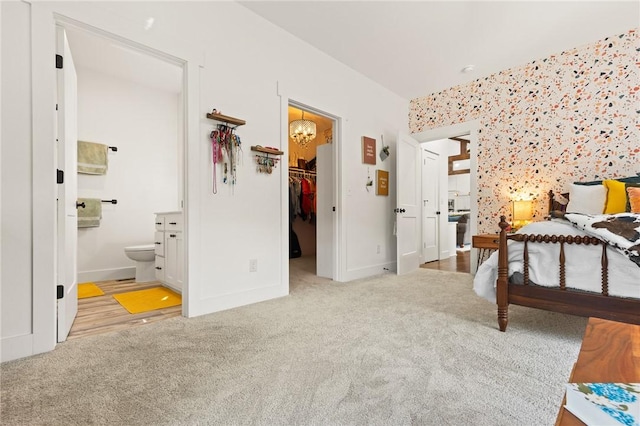 bedroom with carpet floors, baseboards, a walk in closet, and a closet