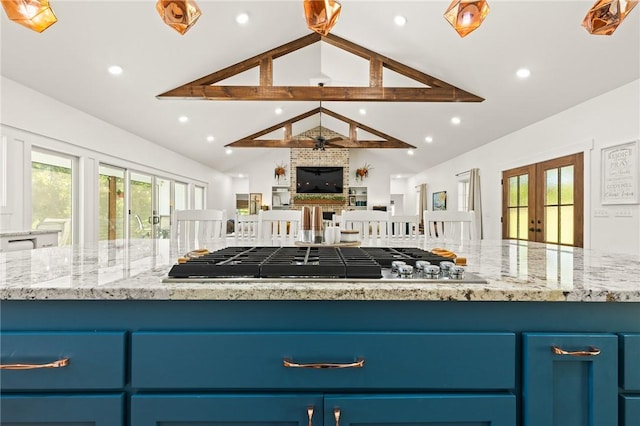 kitchen with blue cabinets, open floor plan, french doors, a wealth of natural light, and stainless steel gas stovetop