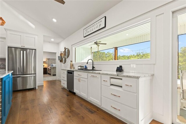 3205 Mc 4021, Everton, AR 72633 - kitchen with appliances with stainless steel finishes, ceiling fan, white cabinetry, lofted ceiling, and light stone counters