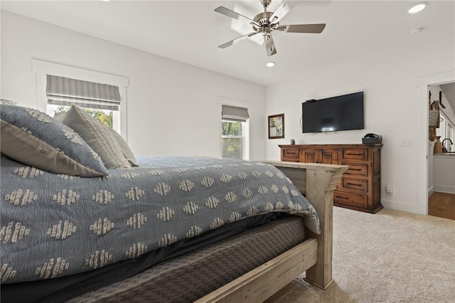 carpeted bedroom with ceiling fan, baseboards, and recessed lighting