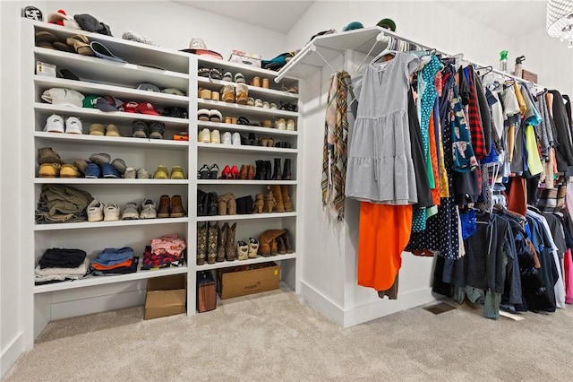 walk in closet with carpet floors