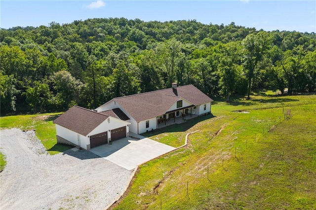 birds eye view of property with a view of trees