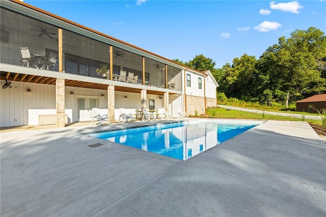 outdoor pool featuring a patio area, a ceiling fan, and french doors