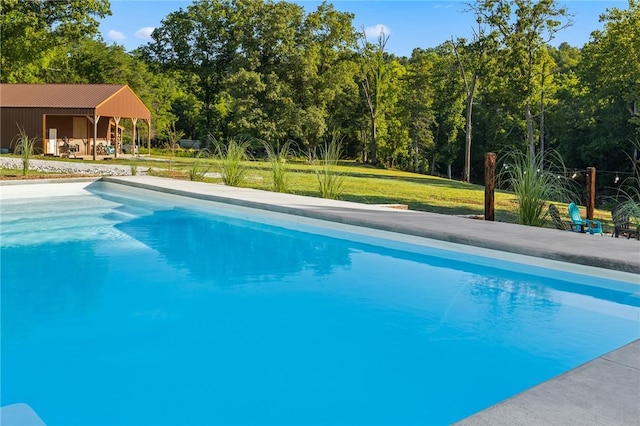 outdoor pool with a yard