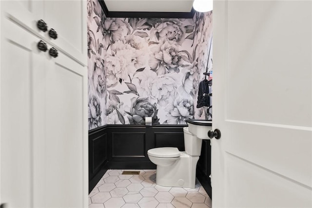 3205 Mc 4021, Everton, AR 72633 - bathroom with wallpapered walls, wainscoting, a decorative wall, and tile patterned floors