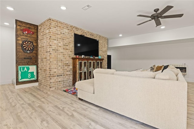 living area with a ceiling fan, recessed lighting, visible vents, and wood finished floors