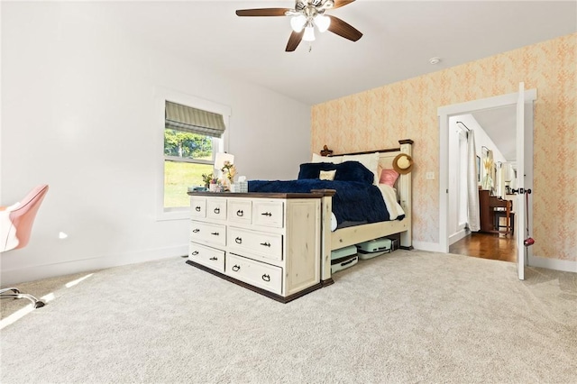 bedroom featuring carpet floors, a ceiling fan, baseboards, and wallpapered walls