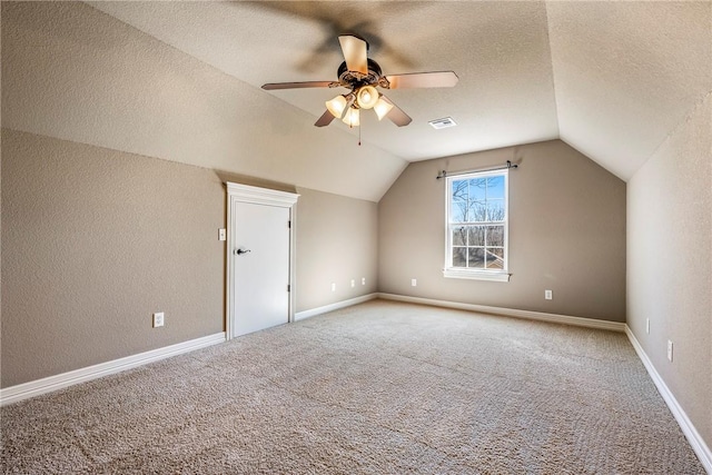 bonus room featuring visible vents, ceiling fan, vaulted ceiling, a textured ceiling, and carpet floors