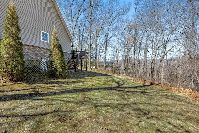 view of yard with stairs and a deck