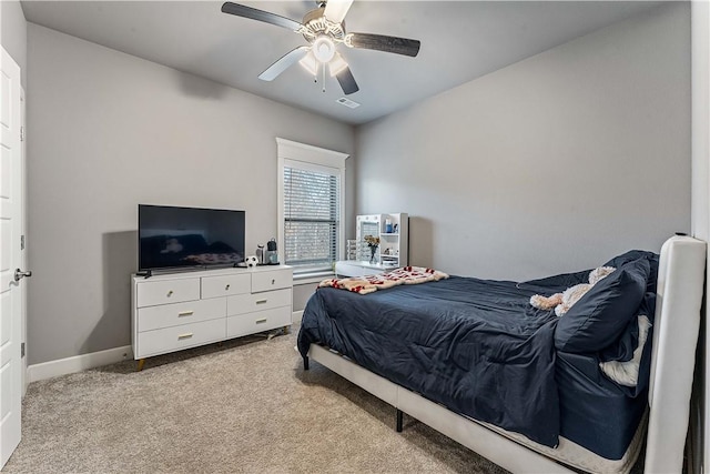 bedroom featuring a ceiling fan, light carpet, visible vents, and baseboards