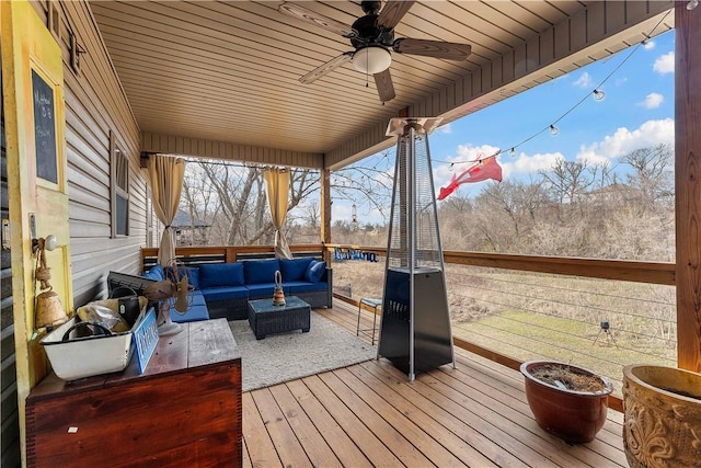 wooden terrace featuring ceiling fan and outdoor lounge area