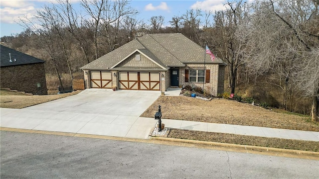 craftsman-style house with concrete driveway, brick siding, an attached garage, and roof with shingles