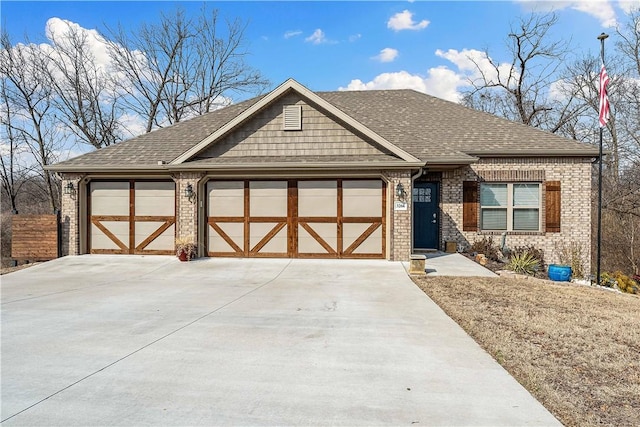 view of front of house with a garage, concrete driveway, brick siding, and roof with shingles