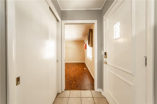 doorway to outside with baseboards and light tile patterned flooring