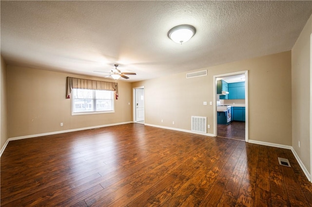 unfurnished room featuring a ceiling fan, visible vents, and dark wood-style flooring