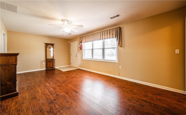 unfurnished living room featuring a ceiling fan, baseboards, visible vents, and hardwood / wood-style floors