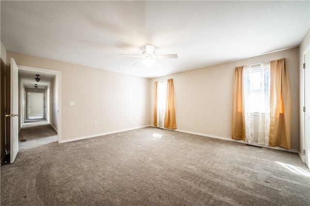 empty room with carpet, baseboards, and ceiling fan