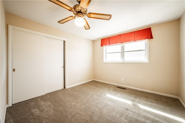 unfurnished bedroom with visible vents, a ceiling fan, baseboards, a closet, and carpet